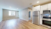 Located at 728 S Lipan St in Denver, CO, this well-appointed one-bedroom, one-bathroom unit offers a thoughtfully designed single-floor layout with modern finishes throughout. The open-concept living area features light-toned hardwood-style flooring, neutral gray walls, and recessed lighting, creating a bright and airy atmosphere. Large windows allow natural light to fill the space, while a door leads directly to a private balcony with neighborhood views.

The kitchen is equipped with crisp white cabinetry, granite-style countertops, and a full suite of stainless steel appliances including a refrigerator, range, microwave, and dishwasher. The seamless flow between the kitchen and living area makes the layout feel open and functional.

The bedroom is generously sized, finished with plush carpeting, a ceiling fan, dual windows, and access to a walk-in closet with built-in shelving. The full bathroom features a dual-sink vanity with granite countertops, a large mirror with modern lighting fixtures, and wood-look tile flooring. Additional highlights include three closets for ample storage, an in-unit laundry area, and a hallway connecting the living spaces efficiently. The overall aesthetic is clean, contemporary, and move-in ready.