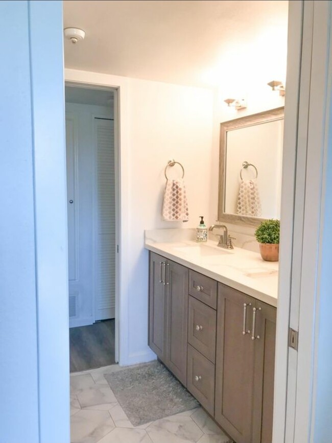 Newly remodeled bathroom with quartz counters & double vanity - 550 Orange Ave