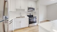 Located at 31 Campbell Crt in Stratford, Ontario, this thoughtfully updated 2-bedroom, 1-bathroom unit offers a clean, modern aesthetic throughout its single-floor layout. Light wood laminate flooring flows seamlessly across the space, complemented by crisp white walls and bright, neutral tones that create a welcoming and airy atmosphere.

The open combined living and dining area is generously proportioned, bathed in natural light through large windows and a sliding glass door that leads to a private balcony with outdoor views. Baseboard heating runs along the perimeter, ensuring comfortable year-round living.

The kitchen is a standout feature, outfitted with white shaker-style cabinetry extending to the ceiling, light quartz countertops, and a full suite of stainless steel appliances including a refrigerator, dishwasher, electric range, and over-the-range microwave. Recessed lighting adds a polished finish to the space.

Both bedrooms are well-sized and bright, with the primary bedroom offering a particularly comfortable footprint. Ample storage is provided throughout the unit, with four closets conveniently distributed across the floor plan. The full bathroom features a clean white tub-shower combination with accessible grab bars, a vanity, and matching wood-tone flooring. A dedicated entrance and hallway complete the functional, well-organized layout.