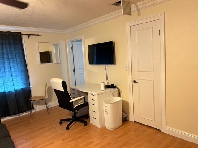view of desk and smart TV - 600 NW 7th Ave