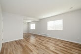 Located at 524 N Juanita Ave in Redondo Beach, CA, this two-story home offers a clean, modern aesthetic throughout. Light wood luxury flooring runs continuously across both levels, lending warmth and cohesion to every room. The main level features an open living area bathed in natural light from large windows dressed with white blinds, complemented by a staircase with a sleek white railing. The galley-style kitchen is thoughtfully designed with light wood cabinetry, quartz countertops, stainless steel appliances, and recessed lighting. A dedicated dining area features a stylish sputnik chandelier and additional window views. A half bath on the main level includes a modern vanity with a quartz countertop and brushed gold accents. Upstairs, spacious bedrooms are equipped with ceiling fans and generous natural light. One bedroom features sliding glass doors opening to a private balcony with outdoor views, while another includes a mirrored sliding-door closet. A full bathroom upstairs offers a soaking tub with an overhead rain shower, quartz countertops, and wood-toned cabinetry. Throughout the home, the neutral color palette, abundant natural light, and consistent modern finishes create a bright, airy atmosphere well-suited to coastal California living.