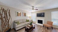Located at 2525 Bolton Boone Dr in DeSoto, TX, this single-floor, one-bedroom, one-bathroom residence offers a thoughtfully designed layout that maximizes comfort and functionality. The welcoming entrance flows into a combined living and dining area highlighted by warm wood-style flooring, a ceiling fan, and abundant natural light from multiple windows with blinds. A white brick fireplace serves as a focal point in the living room, adding character and warmth to the space. The dining area comfortably accommodates a round table and is brightened by a window overlooking the exterior. The galley-style kitchen features white cabinetry, light countertops, black appliances including a range and refrigerator, and a dishwasher — all efficiently arranged for ease of use. The generously sized bedroom offers carpeted flooring, a ceiling fan, a window with outdoor views, and access to an ample walk-in closet with dual hanging rods for storage. Two additional closets provide further organizational flexibility throughout the unit. The bathroom includes a full tub/shower combination with clean white finishes and wood-style flooring. A private patio rounds out the space, offering an outdoor retreat. Multiple hallways connect the rooms seamlessly, creating a cohesive and practical floor plan.