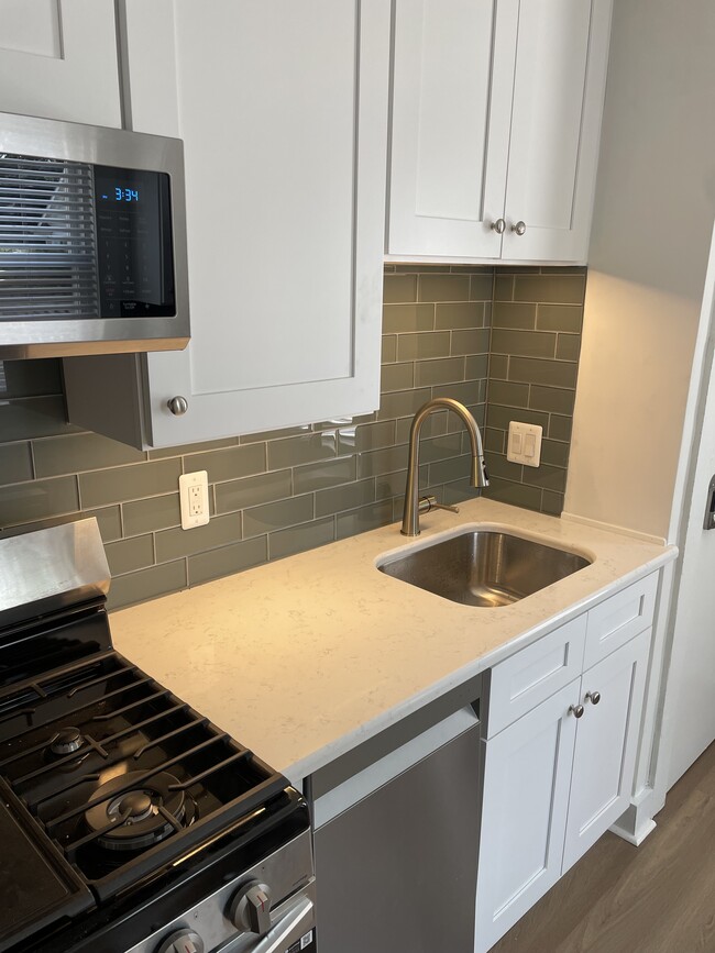 New range and sink with garbage disposal. - 137 Muir Rd