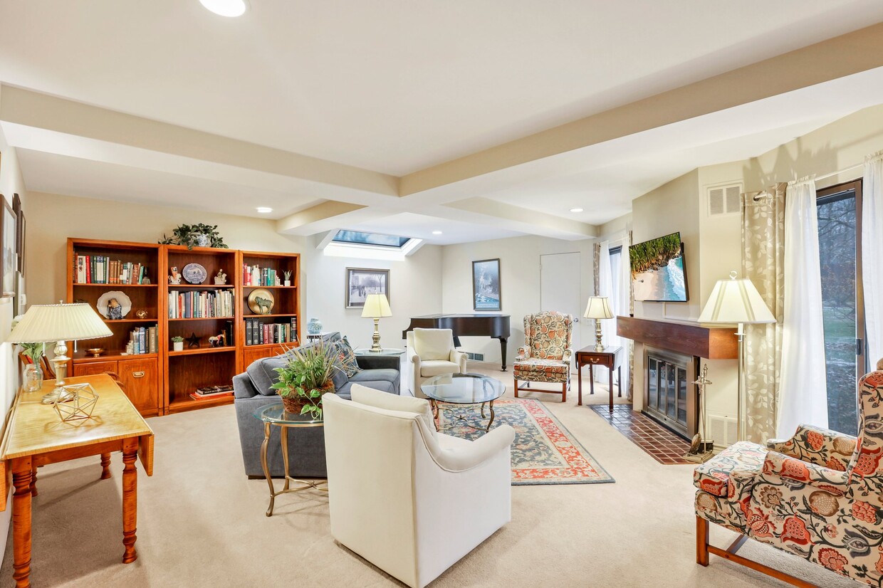 Living room has it all...flat screen tv, books, serenity, and a piano to boot! - 162 Denison Dr