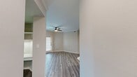 This contemporary 950 square foot apartment in Cedar Park, Texas offers a thoughtfully designed living space. The open floor plan seamlessly integrates the kitchen and living areas, creating an airy atmosphere. The kitchen boasts modern stainless steel appliances, gray cabinetry, and a convenient breakfast bar, perfect for casual dining or entertaining.

Throughout the apartment, wood-look flooring adds warmth and durability. The neutral color palette, featuring light beige walls, creates a versatile backdrop for various decor styles. Large windows in the living area and bedrooms allow ample natural light to flood the space, enhancing the sense of openness.

The primary bedroom, measuring 180 square feet, provides a spacious retreat. Both bedrooms feature ceiling fans and generous closet space. The two bathrooms are outfitted with sleek fixtures, including glass-enclosed showers with modern tile work.

Additional amenities include in-unit laundry facilities and central air conditioning. The apartment's layout efficiently utilizes the available space, offering a comfortable and functional living environment. Its location at 1600 S Lakeline Blvd in Cedar Park provides convenient access to local amenities and transportation routes.