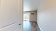 This efficiently designed 2-bedroom, 1-bathroom single-story home in Livermore, California offers a thoughtfully organized layout across its single floor. The living area serves as the heart of the home, featuring wood-look laminate flooring, neutral gray walls, and a ceiling fan. A sliding glass door floods the space with natural light and provides direct access to a private outdoor patio, enhancing the sense of openness.

The kitchen is outfitted with stainless steel appliances, including a refrigerator, electric range, and over-the-range microwave, complemented by white shaker-style cabinetry and light countertops. Wood-look flooring continues seamlessly throughout this area.

Both bedrooms feature plush carpet, ceiling fans, and sliding-door closets with built-in rods for ample storage. One bedroom benefits from a window with views of surrounding greenery, adding a natural element to the space.

The bathroom is finished with wood-look flooring, a white vanity with brushed nickel hardware, a full tub-shower combination, and a large mirror. The clean, neutral palette throughout creates a cohesive and move-in ready environment.