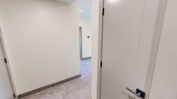 This contemporary 720 square foot apartment in Calgary offers a thoughtfully designed living space with two bedrooms and two bathrooms. The open-concept layout maximizes the use of space, creating a seamless flow between rooms. The kitchen is a standout feature, boasting sleek wooden cabinetry, stainless steel appliances, and a spacious island with a built-in sink, perfect for both meal preparation and casual dining.

Large windows throughout the apartment flood the rooms with natural light and provide urban views of Calgary. The primary bedroom, measuring 150 square feet, offers ample space for rest and relaxation. Both bathrooms are equipped with modern fixtures, including a walk-in shower in one and a bathtub in the other, complemented by stylish tile work and efficient storage solutions.

The apartment's flooring consists of durable, neutral-toned materials that contribute to the overall contemporary aesthetic. Recessed lighting in the kitchen and living areas adds to the modern ambiance, while a combination of ambient and task lighting in other rooms ensures versatile illumination options. The efficient use of space, coupled with the high-quality finishes, creates a comfortable and stylish urban dwelling in the heart of Calgary.