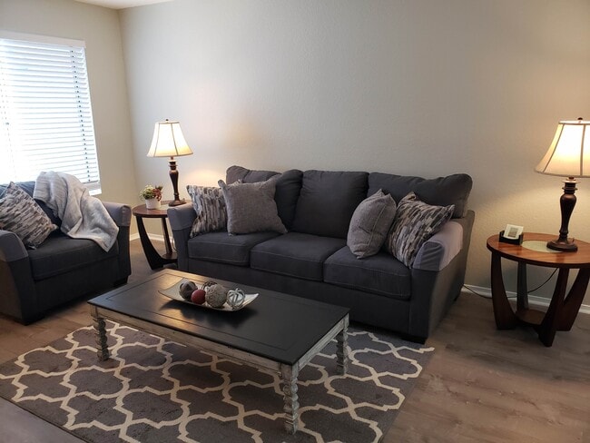 Living room with laminate flooring - 819 Gemstone Ave