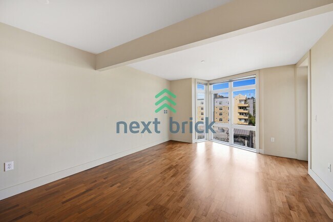 Building Photo - Top-Floor 1-Bedroom + Den with Space Needle Views & Exceptional Building Amenities