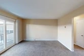 Located at 162 Polk St in Syracuse, NY, this single-floor, 3-bedroom, 1-bathroom unit offers a practical and well-organized layout. The living area is finished with neutral-toned carpet and warm beige walls, creating a clean and inviting atmosphere. Baseboard heating runs along the perimeter, and a sliding glass door opens to a private balcony, allowing natural light to fill the space and providing an outdoor retreat.

The kitchen is equipped with warm oak cabinetry offering ample storage, a double-basin sink, laminate countertops, and white appliances including an electric range and refrigerator. Light wood-style flooring gives the kitchen a bright, functional feel, complemented by a window that brings in additional natural light.

The three bedrooms are carpeted and feature neutral walls, providing a calm environment. The spacious primary bedroom includes a sliding closet for convenient storage. Additional hallway and closet space contribute to the unit's overall organizational efficiency.

The bathroom is finished with classic tile wainscoting, light wood-style flooring, a wood-framed vanity with a mirrored medicine cabinet, and baseboard heating. A connecting door adds accessibility between the bedroom and bath areas. The layout is cohesive and thoughtfully designed for comfortable everyday living.