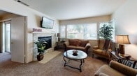 Located at 2020 Cheyenne Way in Modesto, California, this single-story home offers a well-designed layout with comfortable living spaces throughout. The living room serves as the heart of the home, anchored by a striking stacked-stone fireplace with a classic mantel and large windows fitted with white blinds that allow generous natural light to fill the room. Plush carpeting and an open, inviting arrangement make this space ideal for relaxing or entertaining.

The kitchen is equipped with rich wood cabinetry, granite countertops, and stainless steel appliances including a range, over-the-range microwave, and dishwasher. A dining area adjacent to the main living spaces provides a dedicated spot for meals, with easy flow between rooms.

The primary bedroom is generously sized with soft carpet flooring, a window for natural light, and ample room for furnishings. The en-suite bathroom features a dual-sink vanity with granite countertops, white cabinetry, and large mirrors illuminated by overhead lighting. A second bathroom echoes the same granite and white cabinetry finishes, maintaining a cohesive aesthetic throughout.

Additional highlights include an in-unit laundry area and a textured ceiling detail in select rooms. The overall ambiance is warm and functional, making this Modesto home a comfortable and practical residence.