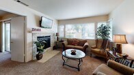 Located at 2020 Cheyenne Way in Modesto, California, this single-story home offers a well-designed layout with comfortable living spaces throughout. The living room serves as the heart of the home, anchored by a striking stacked-stone fireplace with a classic mantel and large windows fitted with white blinds that allow generous natural light to fill the room. Plush carpeting and an open, inviting arrangement make this space ideal for relaxing or entertaining.

The kitchen is equipped with rich wood cabinetry, granite countertops, and stainless steel appliances including a range, over-the-range microwave, and dishwasher. A dining area adjacent to the main living spaces provides a dedicated spot for meals, with easy flow between rooms.

The primary bedroom is generously sized with soft carpet flooring, a window for natural light, and ample room for furnishings. The en-suite bathroom features a dual-sink vanity with granite countertops, white cabinetry, and large mirrors illuminated by overhead lighting. A second bathroom echoes the same granite and white cabinetry finishes, maintaining a cohesive aesthetic throughout.

Additional highlights include an in-unit laundry area and a textured ceiling detail in select rooms. The overall ambiance is warm and functional, making this Modesto home a comfortable and practical residence.