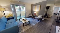 Unit 33 at 2450 Peach Tree Dr in Fairfield, California is a thoughtfully designed single-floor residence that blends contemporary style with everyday functionality. The living room serves as the centerpiece of the unit, featuring rich wood-look flooring, a neutral-toned accent wall, and a large sliding glass door that floods the space with natural light and opens directly onto a private patio — ideal for enjoying outdoor views and fresh air. The kitchen is well-appointed with dark cabinetry, granite-style countertops, and stainless steel appliances, including a full-size refrigerator, dishwasher, and gas range, all complemented by a window that brings in additional natural light. The bedroom offers a warm and inviting atmosphere highlighted by a bold red accent wall, plush carpeting, a window with outdoor views, and ample space for furnishings. The bathroom is clean and functional, featuring wood-look flooring, a granite-topped vanity with dark cabinetry, and a full shower-tub combination. Throughout the unit, consistent design elements — including coordinated dark fixtures and accent artwork — create a cohesive and modern aesthetic that makes this Fairfield residence both practical and visually appealing.