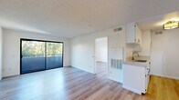 Located at 11817 Victory Blvd in North Hollywood, Los Angeles, this 1-bedroom, 1-bathroom unit offers a well-organized and efficiently designed single-floor layout. The open-concept living and kitchen area forms the heart of the space, featuring light wood laminate flooring and a textured ceiling throughout. Large sliding glass doors in the living area lead to a private balcony, flooding the interior with natural light and offering pleasant views of surrounding greenery.

The galley-style kitchen is thoughtfully designed with white cabinetry, light countertops, a stainless steel sink, and stainless steel appliances including a gas range and refrigerator. A flush-mount ceiling light adds a clean, finished look to the kitchen.

The bedroom is a comfortable, well-lit room with a large window framing tree canopy views, light wood flooring, and crisp white walls, creating a bright and tranquil retreat. Three closets distributed throughout the unit provide generous storage capacity.

The bathroom features a full tub-shower combination with clean white surroundings, chrome fixtures, and wood-tone flooring. The overall aesthetic of the unit is clean and contemporary, with a neutral color palette that maximizes the sense of openness throughout.