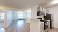 Located at 4605 W Chippewa Cir in Sioux Falls, SD, this single-floor, one-bedroom, one-bathroom residence offers a well-designed layout that maximizes every square foot of its comfortable footprint. Light wood-look flooring flows throughout the main living areas, complemented by crisp white walls and textured ceilings that lend a clean, cohesive aesthetic.

The open-concept kitchen, dining, and living area serves as the heart of the home. The kitchen is outfitted with gray cabinetry, granite-look countertops, a double-basin sink, and stainless steel appliances including a range, microwave, and refrigerator. A peninsula counter provides additional prep space and a natural visual division between the kitchen and the adjoining living area. The living room is bright and airy, with a window unit providing climate control and a baseboard heating system for year-round comfort.

The bedroom offers plush carpeting, a ceiling fan, a natural-light window, and convenient access to closet space. Three closets throughout the unit provide generous storage options. The bathroom features matching gray cabinetry, granite-look countertops, and a full tub-shower combination. A hallway connects the living spaces to the private quarters, maintaining a practical and functional flow throughout the home.
