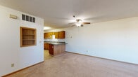 Located at 4768 Golden Pond Ln in Saint Paul, Minnesota, this single-floor, two-bedroom, one-bathroom home offers a practical and well-organized layout across a generously sized floor plan. The open-concept living and dining area features neutral carpet, a textured ceiling, and a ceiling fan, creating a bright and comfortable gathering space with natural light from a framed picture window. The kitchen flows directly from the living area and is outfitted with warm honey-oak cabinetry, dark laminate countertops, a peninsula with a breakfast bar, tile flooring, and white appliances including a range, refrigerator, and dishwasher — providing ample storage and workspace. The primary bedroom is a spacious retreat with plush carpeting and a closet, while the second bedroom also features carpet and a window with natural light. The full bathroom includes a tub-shower combo, wood-accented vanity, and tile flooring. Additional highlights include an attached one-car garage with automatic opener, a dedicated utility room, and a partially framed unfinished space offering potential for future use. The home presents a clean, functional interior suited for comfortable everyday living.