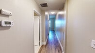 Located at 152 Temple St in New Haven, CT, this single-floor unit offers a clean, modern interior with thoughtful finishes throughout. Durable hardwood-style flooring runs through the main living areas and bedrooms, providing a warm and cohesive aesthetic.

The kitchen is well-appointed with sleek, light-toned cabinetry, stainless steel appliances including a refrigerator, gas range, and built-in microwave, plus a single-basin sink and tile flooring. A track light fixture above adds functional illumination to the workspace. An adjacent dining or living area features matching hardwood-style floors and an open connection to the kitchen space.

The bedrooms are bright and comfortable, each featuring multiple windows dressed with horizontal blinds that allow ample natural light. One bedroom includes a closet with sliding doors, while neutral-toned walls throughout create a calm, versatile backdrop.

The bathroom is cleanly designed with tile flooring, a light wood vanity with a white countertop, a well-lit mirror, and a full tub-shower combination with tile surround.

A central hallway connects the rooms efficiently, finished with the same hardwood-style flooring and crisp white trim. The overall layout, as seen in the floorplan overview, is compact and well-organized, making effective use of the available space.