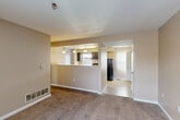 Located at 19311 Votrobeck Dr in Detroit, MI, this multi-story home offers four bedrooms, three bathrooms, and a thoughtfully laid-out floor plan across three levels. The main living floor features a carpeted living room that flows openly toward the kitchen, which is equipped with dark cabinetry, a gas range, refrigerator, dishwasher, and ample counter space. Pendant lighting accents the kitchen area, while a pass-through design connects it to the dining and living spaces. Bedrooms are carpeted with neutral warm-toned walls, and several feature vertical blinds that allow for natural light. The bathrooms are finished with white subway tile wainscoting, vanities with dark cabinetry, and tub-shower combinations. A hallway and multiple staircases connect the floors efficiently, and eight closets throughout the home provide generous storage. The unfinished basement offers significant potential, featuring exposed structural framing, concrete block walls, a utility sink, and mechanicals including a furnace and plumbing infrastructure — ideal for storage or future finishing. A bonus room adds further flexibility to the layout, and dual kitchen spaces make this home uniquely versatile for a variety of living arrangements.