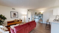 Located at 2201 San Jose Dr in Antioch, CA, this well-appointed one-bedroom, one-bathroom residence offers a thoughtfully designed single-level layout. The open-concept living and kitchen area serves as the heart of the home, featuring wood-look flooring, a textured ceiling, and a ceiling fan that enhance the bright, welcoming atmosphere. The kitchen is outfitted with white shaker cabinetry, quartz countertops, a subway tile backsplash, stainless steel appliances including a refrigerator, range, and microwave, and a peninsula with bar seating — ideal for casual dining. The living room flows seamlessly from the kitchen and dining area, bathed in natural light from a sliding glass door that opens to a private patio with pleasant outdoor views. The bedroom offers ample space, large windows with natural light, and direct access to the full bathroom, which features a clean white vanity and a shower-tub combination. A dedicated in-unit laundry area accommodates a full-sized side-by-side washer and dryer and includes built-in shelving for additional storage. Wood-look flooring carries throughout the unit, tying together the cohesive, modern aesthetic of this efficiently designed home.