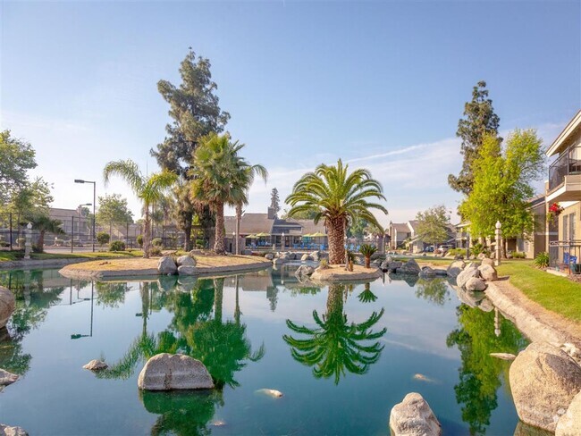 Pond Surrounded by Natural View - Edgewater Isle Apartments and Townhomes