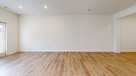 This two-story home in Macon, Georgia offers a clean, modern design across two well-proportioned floors. The main level features an open-concept layout where the living room flows seamlessly into the kitchen, creating a bright and connected living space. The kitchen is equipped with white shaker-style cabinetry, granite countertops, stainless steel appliances including a French door refrigerator, electric range, and microwave, along with a center island that provides additional prep and dining space. Light wood-look luxury vinyl plank flooring runs throughout both floors, contributing to a cohesive and contemporary aesthetic. Recessed lighting illuminates the main living areas, enhancing the airy feel of the space. The attached garage offers convenient enclosed parking and extra storage. Upstairs, three bedrooms are connected by well-lit hallways, with the generously sized primary bedroom offering ample room for furnishings. Four full bathrooms are distributed across the home, each finished with granite-topped vanities, white cabinetry, and tub-shower combinations. Windows throughout the upper level invite natural light and provide views of the surrounding neighborhood. A fenced backyard completes this thoughtfully designed home.