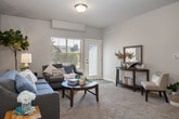 Located at 8448 W Limelight St in Boise, Idaho, this one-bedroom, one-bathroom residence offers a thoughtfully designed single-level floor plan that maximizes every square foot. The entry opens into a welcoming living room finished with plush carpet, a textured ceiling, and a sliding glass door that fills the space with natural light and provides outdoor access. The open-concept kitchen and dining area is a standout feature, boasting a granite-topped breakfast bar with seating, rich dark cabinetry, a tile backsplash, black appliances, and wood-look flooring that flows seamlessly into the adjacent dining space, which is accented by a chandelier and generous wall space for décor. The bedroom is a comfortable retreat, carpeted and brightened by a large window, and complemented by two closets for ample storage. The layout also includes a dedicated laundry area with stacked in-unit washer and dryer hookups and a water heater, adding everyday convenience. Neutral warm tones, consistent finishes, and a well-proportioned layout give the entire residence a cohesive, move-in-ready feel suited for comfortable single-level living in Boise.