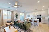 This contemporary 1,580 square foot residence in Avondale, Arizona, offers a thoughtful blend of style and functionality. Spread across two floors, the home features three bedrooms, including a generous 200 square foot primary suite, and four bathrooms. The ground floor spans 600 square feet, while the upper level provides 980 square feet of living space.

The heart of the home is an open-concept area combining the kitchen, dining room, and living room. The kitchen showcases modern white cabinetry, stainless steel appliances, and quartz countertops. Light wood-look flooring throughout the main living areas creates a cohesive and airy feel.

A dedicated laundry room with top-loading washer and dryer, plus ample storage, adds convenience. The bedrooms are well-appointed, with the primary bedroom featuring plush carpeting and a ceiling fan. Bathrooms are sleek and contemporary, with one showcasing a combination tub-shower.

The home's design emphasizes natural light, with multiple windows and sliding glass doors leading to outdoor spaces. Additional features include closet systems for organization and a home office area. The neutral color palette and modern fixtures create a fresh, inviting atmosphere throughout this well-designed Avondale residence.