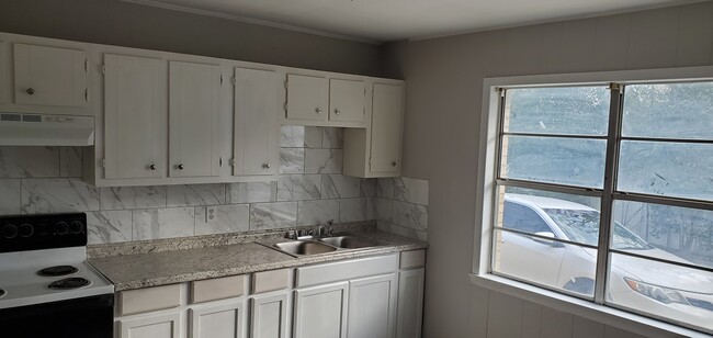 New Cabs and marble backsplash... new flooring. - 307 Blair St