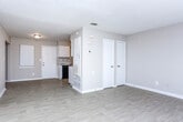 Located at 115 Mitchell Ave in LaGrange, Georgia, this two-floor home offers a practical and well-maintained layout suited for comfortable everyday living. The main level features an open living area with light wood-look flooring that flows seamlessly into a galley-style kitchen. The kitchen is outfitted with white cabinetry, granite-look countertops, a stainless sink, and black appliances including a refrigerator and electric range, providing ample storage and functionality. Multiple closet doors off the living area offer convenient storage access. The primary bedroom on the main level includes light wood-look flooring, a built-in closet with hanging rods, and direct access to a full bathroom. The bathroom features a tub-shower combination, toilet, and a vanity with white cabinetry and a single sink. Upstairs, the second floor hosts additional bedrooms finished with plush neutral carpeting and windows with blinds that allow natural light and outdoor views. Textured ceilings are consistent throughout the home, and neutral wall tones create a clean, cohesive aesthetic. A central staircase connects both floors, as seen in the 3D overview, reinforcing the home's efficient and straightforward floor plan.