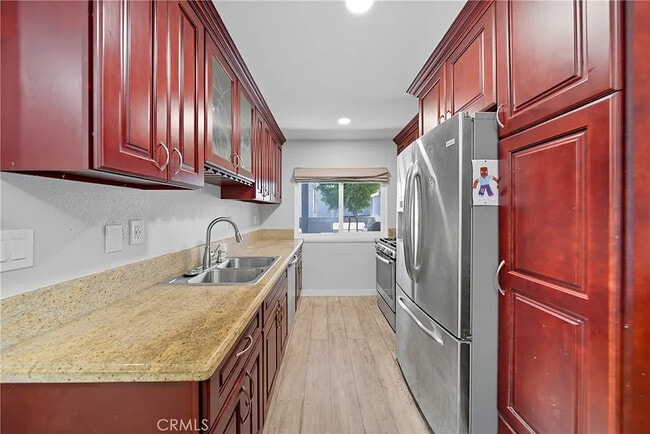 Building Photo - Bright 2-Bed Condo with Central Air, Pool Access & Carport in Anaheim