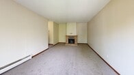 Located at 5705 Quebec Ave N in New Hope, Minnesota, this two-bedroom, two-bathroom residence offers a well-organized single-level layout with a comfortable and functional floor plan. The living room serves as the heart of the home, highlighted by a classic brick fireplace with a raised hearth that adds warmth and character to the space. Plush carpet and neutral walls create a calm, inviting atmosphere throughout the living and bedroom areas. The galley-style kitchen is outfitted with rich wood cabinetry featuring decorative hardware, light laminate countertops, and a full suite of appliances including a refrigerator, electric range, and dishwasher. Light wood-tone flooring runs through the kitchen, which opens toward the living area. Both bedrooms are generously sized, each equipped with ceiling fans and carpeted floors. The spacious primary bedroom includes access to a dedicated closet, while the secondary bedroom benefits from dual windows that invite natural light and outdoor views. Two bathrooms serve the residence — one featuring a tiled tub/shower surround with tile flooring, and the other offering a double-sink vanity with a marble-patterned countertop and tile flooring. Hallways connect the spaces efficiently, and a closet provides additional storage.