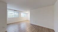 Located at 3600 Ely Pl SE in Washington, DC, this 2-bedroom, 1-bathroom residence offers a thoughtfully arranged single-floor layout. The living areas feature durable hardwood-style flooring and crisp white walls, creating a bright and clean aesthetic. Large windows allow natural light to fill the space, with views of surrounding greenery. A second living area connects seamlessly to the galley-style kitchen, which is equipped with dark cabinetry, a gas range, stainless steel refrigerator, and light countertops — all set atop matching hardwood-style flooring. Both bedrooms are carpeted for comfort and feature double-door closets for ample storage. Natural light enters the bedrooms through window blinds, maintaining a quiet, restful atmosphere. The full bathroom is accessible from the main hallway and includes a shower/tub combination with hardwood-style flooring continuing throughout. Clean white trim and panel-style doors are consistent throughout the home, lending a cohesive and tidy finish. The overall ambiance is functional and well-maintained, making this residence a practical option in the Ely Place neighborhood of Southeast Washington, DC.
