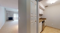 Located at 25 Stanley St in West Hartford, Connecticut, this two-floor residence offers a well-organized and functional layout spread across two levels. The main level features an open living area with plush carpeting, a sliding glass door that leads to an outdoor space, and a brick accent wall that adds a touch of character. A pendant light fixture illuminates the dining area, which connects seamlessly to the kitchen via a pass-through window. The kitchen is outfitted with white cabinetry, granite countertops, stainless steel appliances including a refrigerator, electric range, and dishwasher, complemented by tile flooring. A full bathroom on this level features tile flooring, a granite-topped vanity, and a tub-shower combination enclosed by glass sliding doors with warm stone-tiled surround. Upstairs, a loft-style landing overlooks the lower level and leads to well-sized bedrooms, each with carpet flooring and natural light from sizable windows. One bedroom includes a built-in closet with bi-fold doors. An additional bathroom with tile flooring and a vanity provides convenience on the upper level. Throughout the residence, a neutral color palette and clean finishes create a calm and inviting atmosphere.