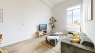 Located in East Los Angeles on E 6th Street, this two-floor home offers a thoughtfully designed layout spread across a spacious main level and a private upper-level bedroom. The main floor encompasses the living, dining, and kitchen areas, along with a full bathroom. Polished concrete floors run throughout the main level, lending an industrial-modern character to the space. The kitchen is outfitted with warm wood-grain cabinetry, a stainless steel range, a built-in hood vent, and clean white countertops — combining both style and function. A sleek, space-saving steel staircase connects the main floor to the upper level, serving as a striking architectural focal point. The living area is bright and open, featuring a large window that invites natural light and offers city views, with ample wall space ideal for personalization. The bathroom is clean and minimal, featuring a glass-enclosed shower with tile surround and polished fixtures. Upstairs, the private bedroom features light wood flooring, white walls, and a calm, restful atmosphere — providing a distinct separation from the main living areas. Throughout the home, the design balances modern minimalism with warm natural materials, creating a cohesive and functional living environment.