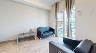 Located at 256 Lester Street in Waterloo, Ontario, this two-bedroom, one-bathroom unit offers a well-designed single-floor layout with a clean, contemporary aesthetic throughout. Light-toned hardwood-style flooring runs continuously across the main living areas, creating a cohesive and airy feel.

The kitchen is a standout feature, outfitted with two-tone cabinetry — crisp white upper cabinets paired with dark lower cabinets — granite-style countertops, a marble-effect tile backsplash, and a full suite of stainless steel appliances including a refrigerator, stove, and dishwasher. The living room benefits from large floor-to-ceiling windows dressed with neutral curtains, filling the space with natural light and offering open urban views of the surrounding Waterloo skyline.

The primary bedroom is a comfortable size, featuring multiple windows that invite natural light and provide city views, with drape treatments for privacy. The second bedroom includes a closet and its own window with an urban outlook. Both rooms are finished in neutral tones that complement the light flooring. The bathroom is functional and clean, finished with large-format grey floor tiles and a shower-tub combination. This unit combines practical design with modern finishes in a prime Waterloo location.