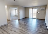 This contemporary 800 square foot apartment in West Des Moines offers a thoughtful layout with 2 bedrooms and 2 bathrooms. The open-concept design seamlessly integrates the living room and kitchen, creating a spacious feel. The kitchen boasts modern white cabinetry, sleek black appliances, and a convenient breakfast bar. Wood-look flooring throughout the main living areas adds warmth and durability.

The primary bedroom, measuring 160 square feet, provides ample space and features plush carpeting for comfort. Both bathrooms are updated with clean white fixtures and wood-look flooring. The apartment includes a generously-sized closet with built-in shelving and hanging rods for optimal organization.

Large windows in the living area and bedrooms allow natural light to flood the space, while a sliding glass door leads to an outdoor area. The apartment is equipped with modern amenities such as a ceiling fan and window air conditioning unit. With its neutral color palette and contemporary finishes, this apartment offers a blank canvas for personalization while providing all the essentials for comfortable living.