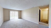 Located at 1305 W Vistula St in Bristol, Indiana, this single-floor, one-bedroom, one-bathroom residence offers a practical and comfortable layout. The living room is a generously sized, carpeted space finished with neutral beige walls, a textured ceiling, and a sliding glass door fitted with vertical blinds that allows natural light to fill the room and provides a view of the surrounding outdoors. A subtle chair-rail-style molding detail adds a touch of architectural character to the walls.

The kitchen features dark espresso-toned cabinetry contrasted against lighter countertops and tile flooring, with a white electric range anchoring the cooking area. The space connects efficiently to the rest of the unit, offering a functional flow throughout.

The bedroom is a well-proportioned, carpeted room with a natural wood-toned door, a window overlooking a wooded outdoor view, and a built-in closet with bifold doors providing ample storage. The neutral color palette continues throughout, creating a cohesive and calm ambiance.

The bathroom is cleanly appointed with tile flooring, a tub-shower combination with white tile surround, a toilet, and a vanity with white cabinetry, a mirrored medicine cabinet, and a lighted fixture above. The overall atmosphere of the residence is functional, understated, and move-in ready.