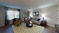 This single-floor, two-bedroom, one-bathroom residence in Barrington offers a well-organized layout designed for comfortable everyday living. The living room serves as the central gathering space, featuring wood-style flooring, neutral-toned walls, and ample natural light streaming through large windows with blinds and drapes. The open layout connects seamlessly to the dining area, which is distinguished by a bold accent wall and convenient bar-height seating along the kitchen pass-through counter.

The kitchen is thoughtfully designed with warm wood cabinetry, granite-style countertops, stainless steel appliances including a dishwasher and range, and a built-in microwave — providing generous storage and functionality.

Both bedrooms are carpeted and include ceiling fans with integrated lighting. The primary bedroom is spacious enough to accommodate a full bedroom suite, while the second bedroom offers a comfortable and cozy layout with natural light from a window. Each room maintains a neutral palette, contributing to a calm and versatile atmosphere.

The bathroom features wood-style flooring, a vanity with granite-style countertops, warm wood cabinetry, and a clean, practical design. Overall, the residence offers a cohesive and functional living environment with consistent finishes throughout.