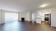 Located at 18418 Dearborn St in Northridge, CA, this well-appointed 2-bedroom, 4-bathroom residence offers a thoughtfully designed single-level layout. The open living area is anchored by rich dark hardwood flooring and a classic fireplace, with a large sliding glass door providing natural light and direct access to a private balcony. The kitchen is outfitted with white cabinetry, light countertops, a peninsula with bar seating, and a full suite of stainless steel appliances including a gas range, built-in microwave, dishwasher, and refrigerator. A dedicated dining room complements the living and kitchen spaces for versatile everyday living. Both bedrooms feature plush carpeting, vertical blinds, and generous closet space — including mirrored sliding-door closets and open shelving systems. The spacious primary bedroom includes an en-suite bathroom with a wide vanity, ample cabinet storage, and hardwood flooring. Additional bathrooms are finished with white vanities, tub-shower combos with glass enclosures, and matching hardwood floors. With seven closets spread throughout, storage is a defining feature of this home. The clean, neutral palette and consistent finishes create a bright, cohesive atmosphere throughout.