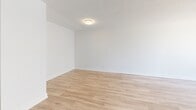 Located on the third floor at 129 Wellington Street in Brantford, Ontario, this 2-bedroom, 1-bathroom unit offers a compact yet efficiently designed layout finished with consistent light wood laminate flooring throughout. The living room is a bright, open space anchored by large sliding glass doors that lead to a balcony, allowing natural light to fill the room while providing views of the surrounding cityscape. The open sightline toward the kitchen and entryway adds to the sense of flow within the unit.

The primary bedroom is a well-proportioned room featuring a wide, floor-to-ceiling sliding closet and a large multi-pane window with baseboard heating beneath it, offering ample natural light and urban views. The second bedroom is similarly finished, with its own window, baseboard heater, and a built-in closet, providing practical storage in a clean, neutral space.

The bathroom is finished with white subway tile surrounding the soaker tub and shower combination, complemented by grey floor tile, a clean white toilet, and simple chrome fixtures — presenting a crisp, functional aesthetic. Throughout the unit, white walls and bright trim maintain a clean, modern appearance, creating a cohesive and move-in ready living environment.