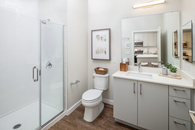 Finish Scheme II bath with white quartz countertop, light grey cabinetry, and hard-surface flooring (representative photo) - Avalon Governors Park