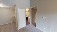 Located at 4858 River Ranch Blvd in Fort Worth, TX, this single-story unit offers a thoughtfully designed layout with a variety of functional living spaces. The entry opens into a generously sized living area distinguished by notably high ceilings that lend a sense of openness and volume. A standout feature of the living room is the fireplace framed by a raised tile hearth and flanked by built-in shelving, providing both a focal point and practical storage. A sliding glass door allows natural light to filter in and offers views of the outdoors.

The kitchen is well-appointed with white shaker-style cabinetry, light quartz countertops, and a striking dark subway tile backsplash. Black appliances, including a range and dishwasher, complement the design, while wood-look flooring grounds the space with warmth.

The bedrooms are carpeted and finished in neutral tones, each with windows that bring in natural light. Two bathrooms feature tub-shower combinations with white tile surrounds, wood-look flooring, and clean, understated finishes. Throughout the unit, a consistent neutral color palette and textured ceilings create a cohesive, comfortable atmosphere.