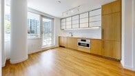 Located at 1770 Pendrell St in Vancouver's desirable West End, this modern 2-bedroom, 1-bathroom unit offers a thoughtfully designed layout across a single floor. Warm-toned hardwood flooring flows consistently throughout the space, creating a cohesive and inviting atmosphere.

The kitchen is a standout feature, showcasing a clean, contemporary design with two-tone cabinetry — natural wood lower cabinets paired with white upper cabinets — complemented by matte black fixtures, a built-in oven, and a sleek countertop. A large window floods the kitchen with natural light and frames views of the surrounding Vancouver skyline.

The generously sized primary bedroom benefits from ample natural light through a dedicated window with neighbourhood views, and features a sliding frosted-glass door that adds a modern, space-conscious touch. The second bedroom offers a clean, bright space with the same warm hardwood flooring and crisp white walls.

The bathroom is finished to a high standard, featuring large-format dark grey tile work on both the floors and walls, a floating wood vanity with a vessel sink, matte black fixtures, and mirrored upper cabinetry — delivering a spa-like aesthetic. An entrance completes the unit's functional layout, making this a well-rounded and modern urban residence.