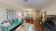 This single-story, one-bedroom, one-bathroom residence in New Orleans, Louisiana offers a thoughtfully designed layout that maximizes its well-proportioned footprint. The open-concept living and dining area serves as the heart of the home, featuring rich wood-style flooring, neutral walls, and natural light filtering in through sliding glass doors that lead to an exterior access point. The living space comfortably accommodates both a seating and dining arrangement, with a pendant light fixture accentuating the dining zone.

The kitchen is positioned adjacent to the main living area and features a pass-through window that enhances the open feel. White cabinetry, white appliances including a range and built-in microwave, and light countertops create a clean, cohesive look. A skylight above adds a welcome source of natural illumination.

The bedroom is a calm retreat with plush carpeting, a ceiling fan with light fixture, and a window dressed with sheer curtains that allow soft natural light. The full bathroom includes a single-sink vanity with a large mirror, a tub-shower combination, and textured walls that add subtle character. Overall, the space maintains a bright, airy ambiance throughout.