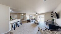 Located at 1950 S Scenic Ave in Springfield, MO, this single-story 2-bedroom, 2-bathroom home offers a well-designed, functional layout across a comfortable footprint. The open living room is carpeted and filled with natural light from a sliding glass door that leads to an outdoor patio, complemented by a ceiling fan overhead. The adjacent dining area features wood-style flooring, providing a seamless transition from the carpeted living space. The kitchen is outfitted with warm wood cabinetry and a breakfast bar with seating, making it ideal for casual dining. Two carpeted hallways connect the main living areas to the private quarters, offering a natural flow throughout. The generously sized primary bedroom benefits from multiple windows that invite abundant natural light and features its own ceiling fan. The two bathrooms are finished with tile flooring and warm wood vanities — one includes a walk-in shower with glass doors, and the other offers a full shower-tub combo. A dedicated laundry room with tile flooring accommodates a full-size washer and dryer. With four closets distributed throughout, storage is plentiful. The neutral color palette and consistent finishes give the entire home a cohesive, move-in-ready feel.