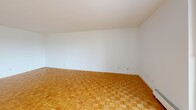 Located at 100 Eighth Avenue in Kitchener, Ontario, this one-bedroom, two-bathroom unit offers a well-organized single-floor layout designed for comfortable everyday living. Warm parquet flooring flows throughout the main living areas and bedroom, lending a classic, cohesive character to the space.

The living room is generously sized, featuring large sliding glass doors that open onto a private balcony overlooking surrounding greenery and the neighbourhood beyond — filling the room with natural light. The spacious primary bedroom includes a window with an outdoor view and the convenience of two closets, offering ample storage.

The kitchen is equipped with warm oak cabinetry, dark granite-style countertops, and a double stainless steel sink, providing a practical and efficient workspace. Light tile flooring ties the kitchen and hallway areas together seamlessly.

Both bathrooms are finished with tile flooring, and one features a full tub-and-shower combination with white subway tile surround, a wood-toned vanity with a granite-style countertop, and accessible grab bars. The hallway connects all rooms cleanly, maintaining an efficient flow throughout.

Overall, the unit presents a bright, functional, and classic interior well-suited for those seeking comfortable living in the Kitchener community.