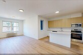This thoughtfully designed one-bedroom, one-bathroom residence at 431 Doctor Martin Luther King Junior Boulevard in East Orange, NJ, offers a clean, contemporary living experience across a single well-organized floor. Light wood flooring runs throughout the space, lending warmth and continuity to every room.

The open-concept kitchen and living area forms the heart of the home. The kitchen is outfitted with warm wood cabinetry extending to the ceiling, white lower cabinets, white quartz countertops, a central island, stainless steel appliances including a refrigerator, range, microwave, and dishwasher, and a stainless undermount sink. Natural light enters through multiple windows, brightening the combined living space.

The bedroom is a well-proportioned private retreat featuring light wood flooring, a window with outdoor views of the surrounding neighborhood, a wall-mounted HVAC unit, and a double-door closet for ample storage. A second closet provides additional organization throughout the unit.

The bathroom is finished in a clean, minimalist style with neutral tile flooring, a white vanity with a stone-topped countertop, and chrome fixtures. A dedicated laundry area adds everyday convenience. The overall aesthetic is bright, modern, and move-in ready.