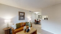 Located at 1400 Blue Bell Rd in Houston, TX, this well-appointed 2-bedroom, 1-bathroom unit offers a thoughtfully designed single-floor layout. Light wood-look flooring flows throughout, complementing the neutral wall tones and textured ceilings that define the interior aesthetic.

The open-concept living room is bright and welcoming, featuring large windows that invite natural light and a front entry door flanked by additional windows. The space flows naturally into a dedicated dining area, creating an ideal zone for daily living and entertaining. Adjacent to the dining room, the kitchen features a galley-style layout with white cabinetry, marble-look countertops, subway tile backsplash, a double-basin sink, and stainless steel appliances including a refrigerator, dishwasher, and range. A dedicated pantry and in-unit laundry add practical convenience.

The primary bedroom is a comfortable retreat with a ceiling fan, a natural light window, and a generously sized walk-in closet with dual hanging rods. The second bedroom also features wood-look flooring and ample closet space. The full bathroom is finished with marble-look tile surrounding a full soaking tub and shower combination. Three closets throughout the unit provide excellent storage throughout this efficient and functional Houston home.