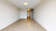 Located at 333 E 11th Ave in Vancouver's vibrant Mount Pleasant neighbourhood, this efficiently designed studio offers a clean, contemporary aesthetic throughout its single-level layout. Light wood-look flooring flows seamlessly across the open living area, complementing the bright white walls and neutral tones that create an airy, welcoming atmosphere.

The living area is generously proportioned for its footprint, highlighted by a large floor-to-ceiling window with blinds that frames elevated views of the surrounding neighbourhood and lets in abundant natural light. A baseboard heater sits beneath the window, ensuring year-round comfort. The space transitions naturally into a functional hallway corridor that connects to the kitchen area, finished with grey cabinetry for a modern touch.

The full bathroom features clean white tile surrounding a full soaker tub and shower combination, neutral floor tiles, and a chrome towel bar, delivering a simple yet polished finish. A dedicated laundry area adds practical convenience within the unit itself.

Overall, the space presents a minimalist, move-in-ready environment with a consistent modern palette, efficient use of space, and thoughtful design details suited to contemporary urban living in one of Vancouver's most sought-after neighbourhoods.