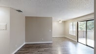 Located at 1180 Fulton Ave in Arden-Arcade, California, this two-bedroom, one-bathroom unit offers a practical and well-organized single-floor layout. The living room serves as the heart of the home, featuring wood-style plank flooring, neutral warm-toned walls, and a textured ceiling. A standout feature is the sliding glass door that opens to a private patio, flooding the space with natural light and offering pleasant views of surrounding greenery.

The kitchen is efficiently designed with ample cabinetry in a light tan finish, granite-style countertops, and a full suite of black and stainless steel appliances including a refrigerator, electric range, and built-in microwave. Wood-style flooring continues throughout, creating a cohesive feel.

Both bedrooms are carpeted and bathed in natural light through well-placed windows that frame views of mature trees. Each room offers a comfortable, versatile footprint, with the primary bedroom providing a notably generous amount of space. A dedicated closet adds practical storage.

The bathroom features wood-look flooring, a vanity with granite-style countertops, warm cabinetry, and a full shower-tub combination. Throughout the unit, a consistent neutral color palette and clean finishes create a calm, move-in-ready atmosphere.